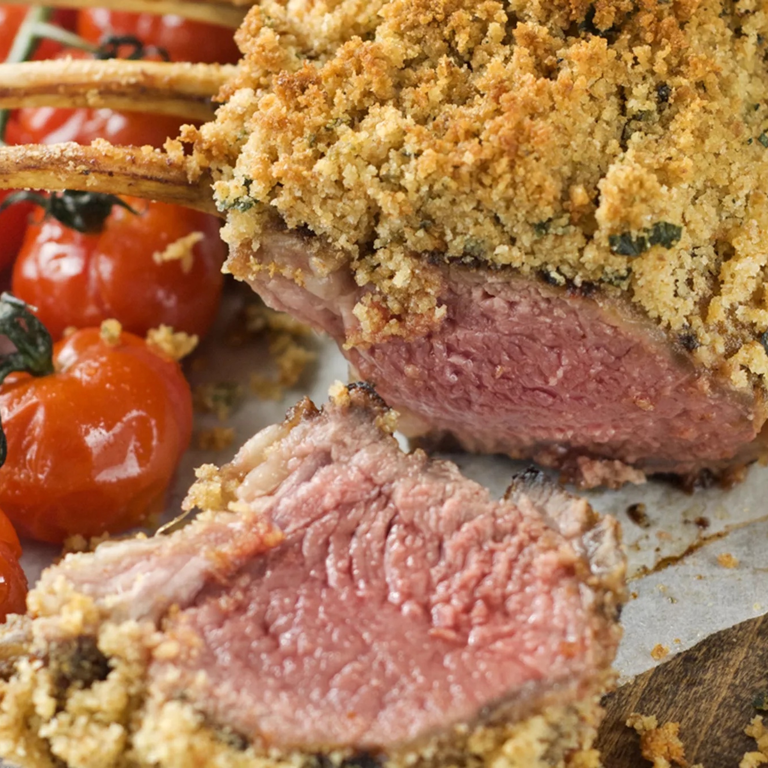 Maple marinated herb crusted rack of lamb with roasted tomatoes